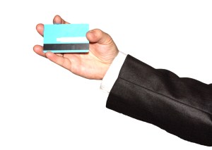 Businessman's hand holding blue credit cards 03. Isolated on whi