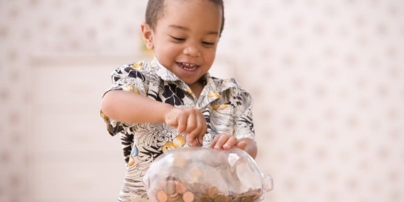 bigstock-Young-boy-putting-money-in-pig-73102693-e1458943484856-1