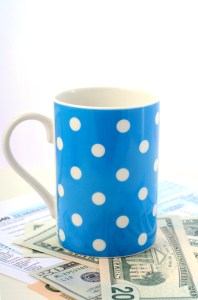 USA Tax Day, April 15, coffee break with tax return, cash and coffee mug, vertical.