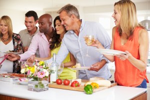 Group Of Mature Friends Enjoying Buffet At Dinner Party